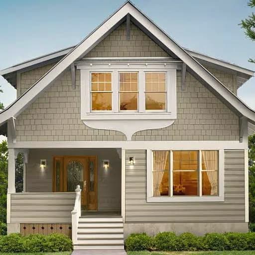 A craftsman-style house at dusk with warm light in its windows